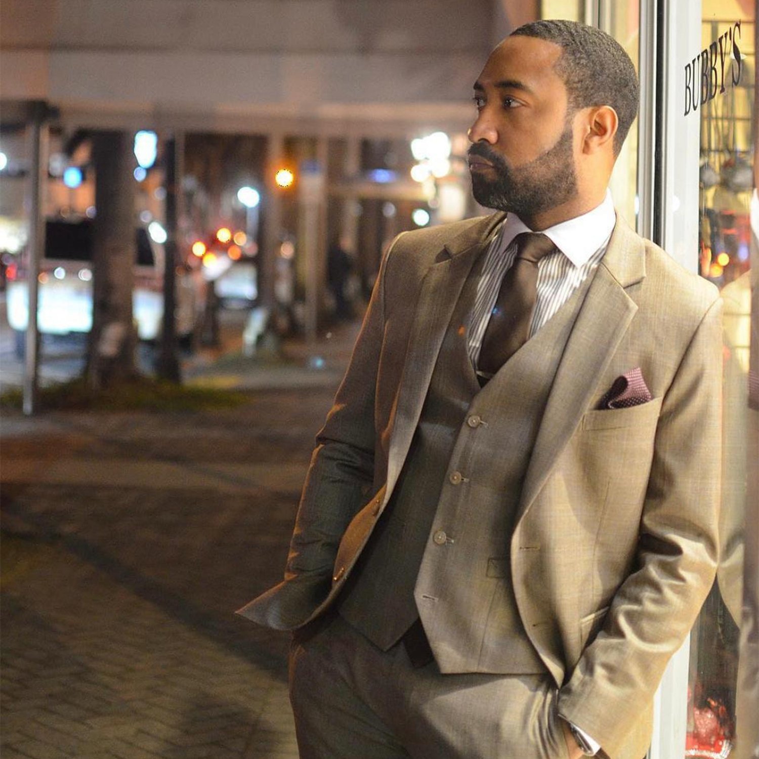 Man wearing a custom beige three-piece suit with a brown tie and pocket square, tailored by JB Custom Tailor in MBK Center, Bangkok
